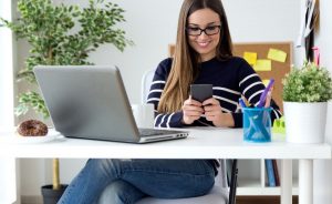 photo of a woman smiling at her phone