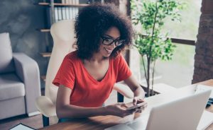 photo of a woman working on a laptop